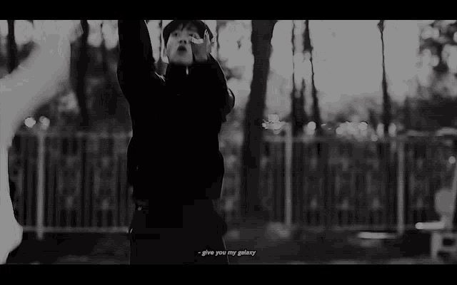 a black and white photo of a person with the words give you my galaxy on the bottom