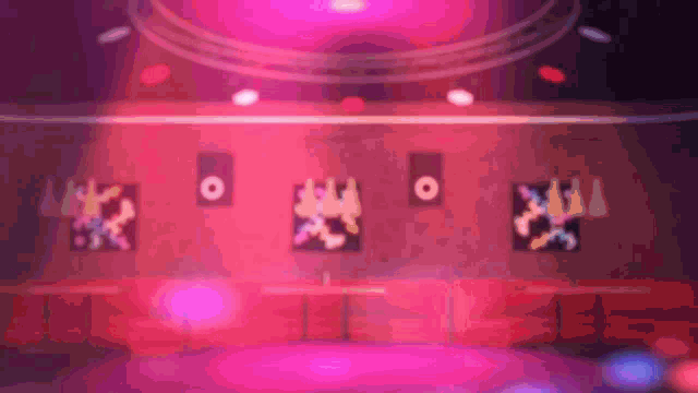 a blurred image of a stage with a few people dancing on it
