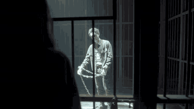a man in a jail cell with chains around his legs