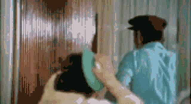a blurry picture of a man and woman standing next to each other .