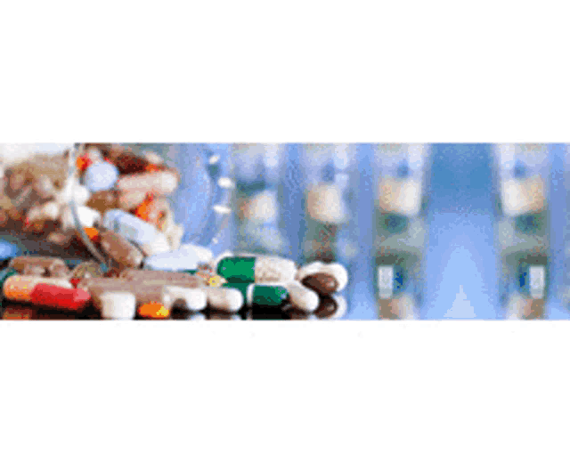 a bunch of pills are sitting on a table in front of a chemical structure