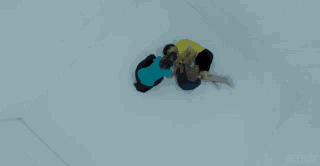 a group of people laying on a white surface with a netflix logo on the bottom