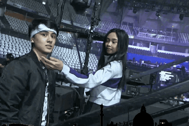 a man with a bandage on his head is being helped by a girl