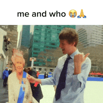 a man holding a cardboard cut out of queen elizabeth