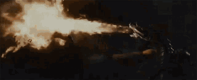 a person is holding a fireball in their hand in the dark