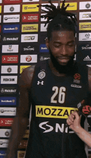 a man with the number 26 on his jersey is being interviewed