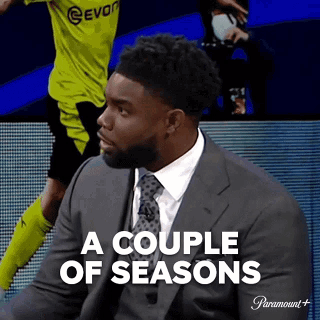 a man in a suit and tie with the words a couple of seasons below him