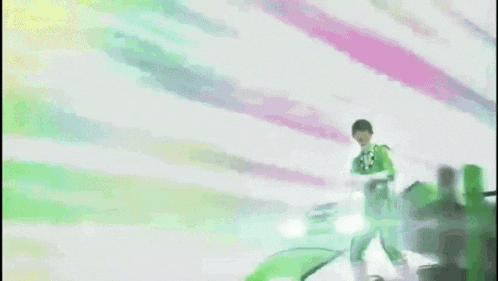 a man in a green suit is fighting a green vehicle .