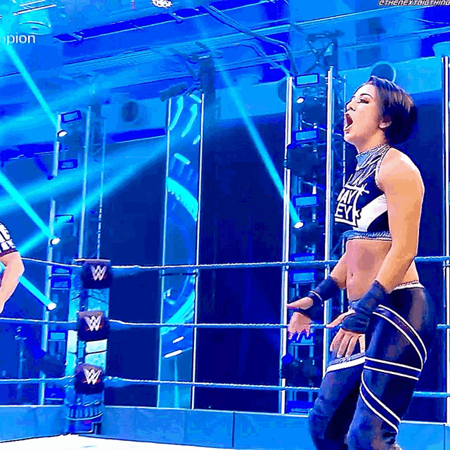 a woman in a wrestling ring is wearing a shirt that says ' i am a beast '