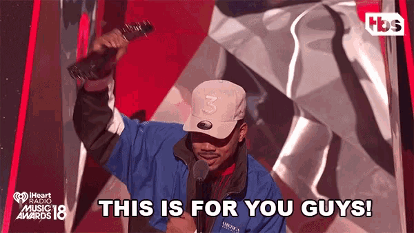a man holding a microphone with the words this is for you guys