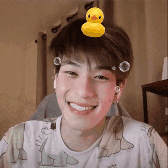 a boy with a rubber duck on his head