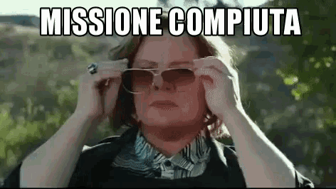 a woman is wearing sunglasses with the words missione compiuta written above her .