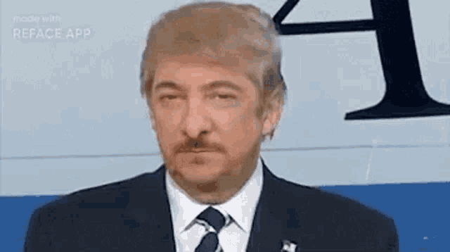a man in a suit and tie is looking at the camera with a fake trump face .