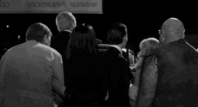 a group of people standing in front of a sign that says mosko brewiere
