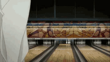 a bowling alley with a stained glass mural on the side