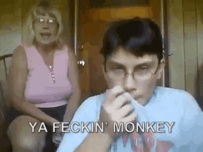 a young boy is smoking a cigarette while a woman sits behind him and says `` ya feckin monkey '' .