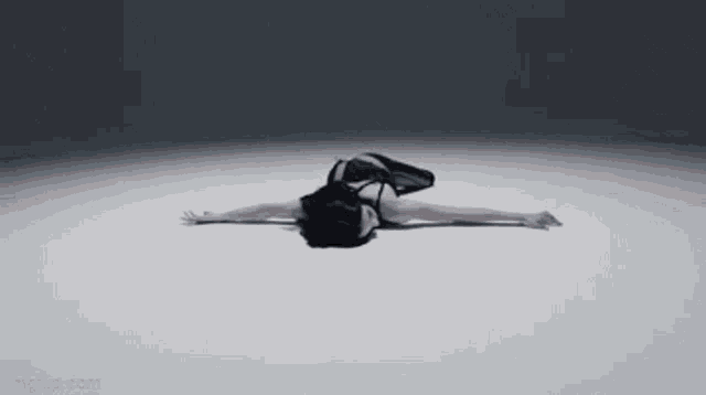 a woman is laying on her back with her arms outstretched