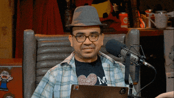 a man wearing a hat and a shirt that says dragon 's heart