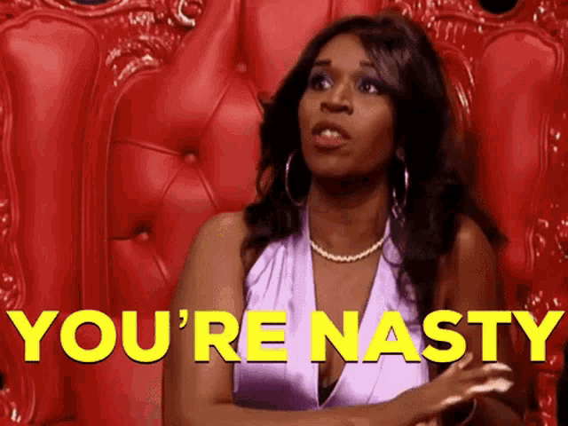 a woman in a purple dress is sitting in a red chair with the words you 're nasty in yellow letters behind her