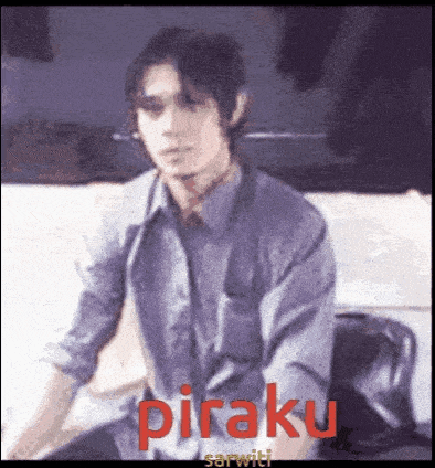 a man in a gray shirt and tie is sitting in front of a white car with the word piraku in red letters