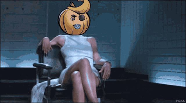 a woman sitting in a chair with a pumpkin on her head