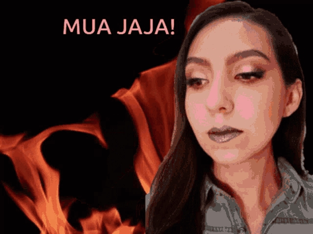 a woman stands in front of a fire and the words mua jaja