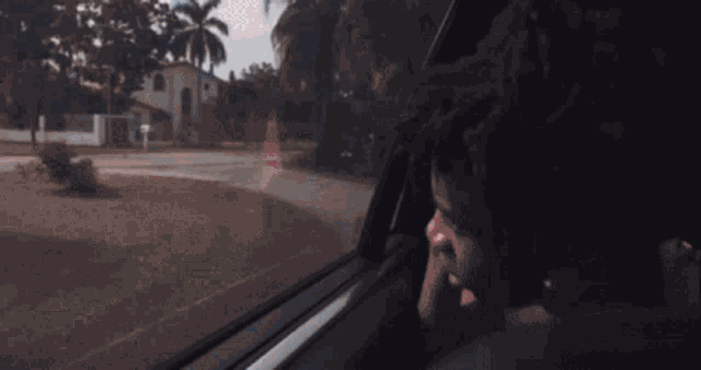a person is looking out of a car window with the word diva on it