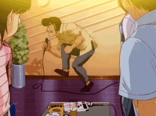 a man is singing into a microphone in front of a table with a magazine that says menu on it