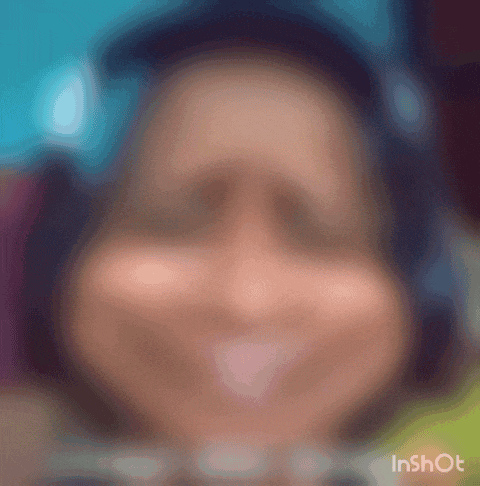 a blurry picture of a person 's face with headphones on .