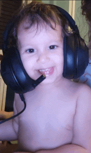 a baby wearing headphones with a microphone attached to it