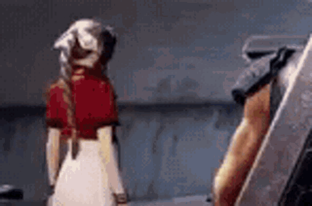 a man and a woman are standing next to each other in a room and talking .