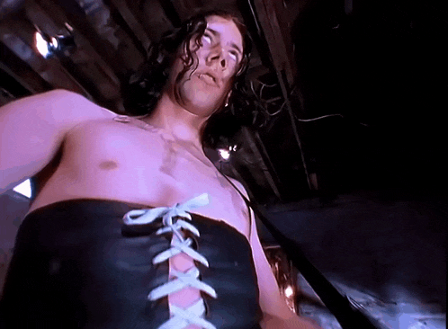 a man without a shirt is wearing a black lace up belt