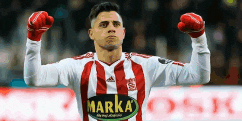 a soccer player wearing a red and white striped shirt with the word marka on the front