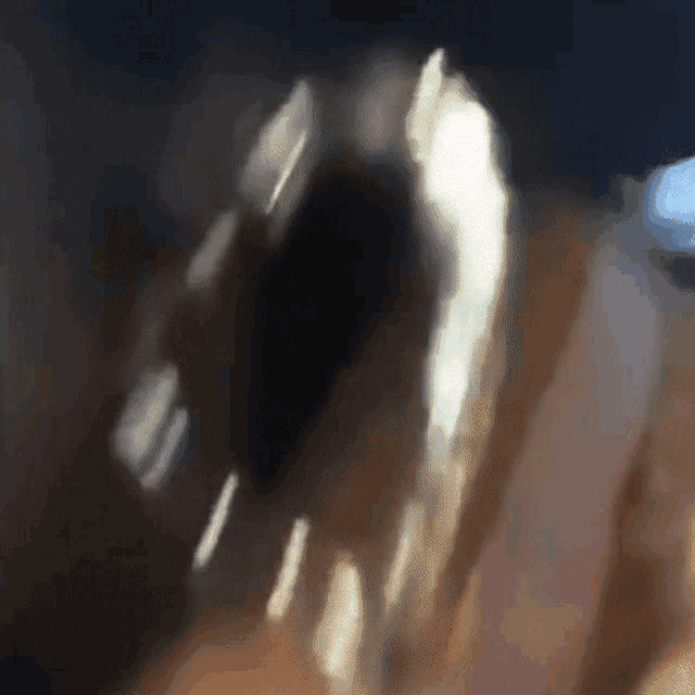 a blurry image of a person 's face with a few spots of light