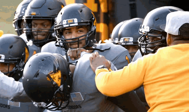 a group of football players with one wearing a helmet that says bruin