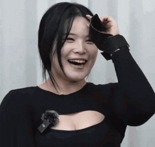 a woman wearing a black top with a microphone on it