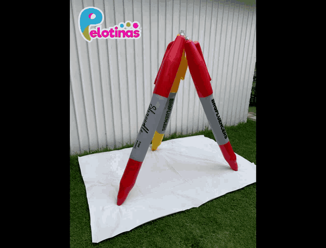 a red and yellow sharpie marker is sitting on a white towel