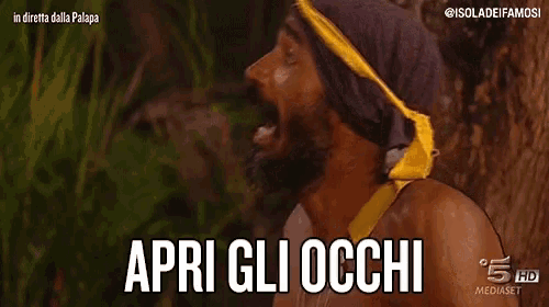 a man with a beard and a bandana on his head is saying apri gli occhi .