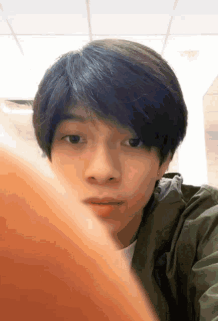 a close up of a young man 's face with a blurred background