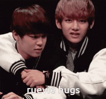 a couple of boys hugging each other with ruevie hugs written in the corner