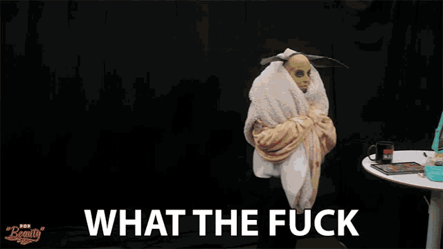 a person wrapped in a blanket with the words " what the fuck " below them