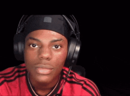 a man wearing headphones and a red shirt with the word show on it
