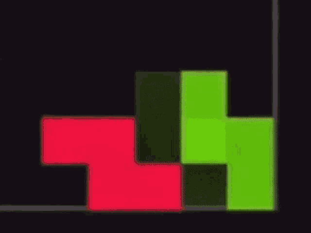 a red and a green tetris block are on a black background .