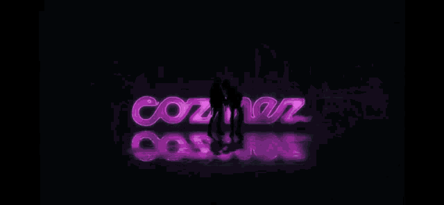 a couple of people standing in front of a sign that says cozner