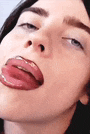 a close up of a person 's face with their tongue out .