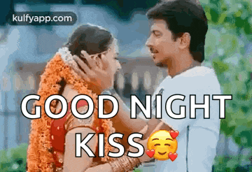 a man and a woman are kissing each other and the words `` good night kiss '' are written on the image .