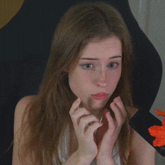 a woman with long hair is making a funny face