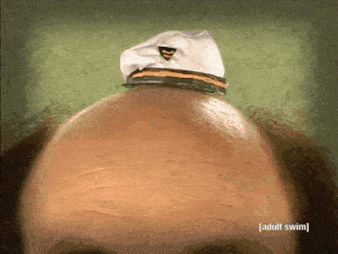 a bald man 's head with a captain 's hat on it