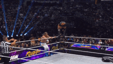 a wrestler in a ring with a banner that says revolution