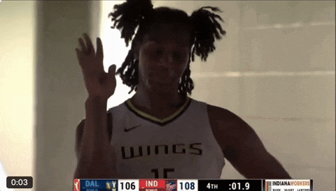 a basketball player wearing a wings jersey waving